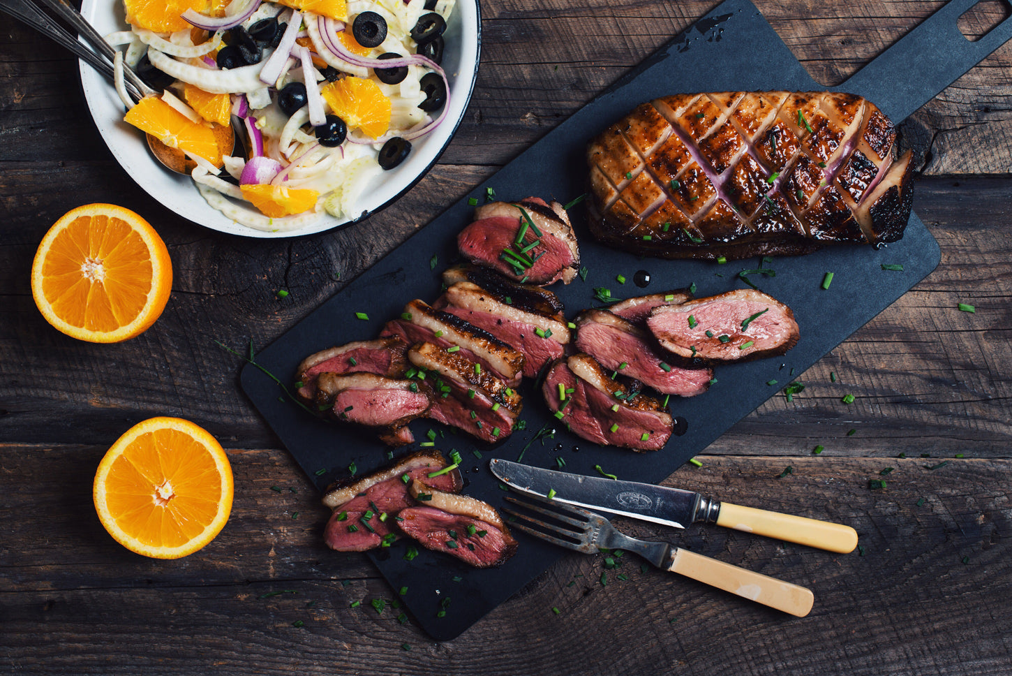 duck breast on slate plate, orange slices