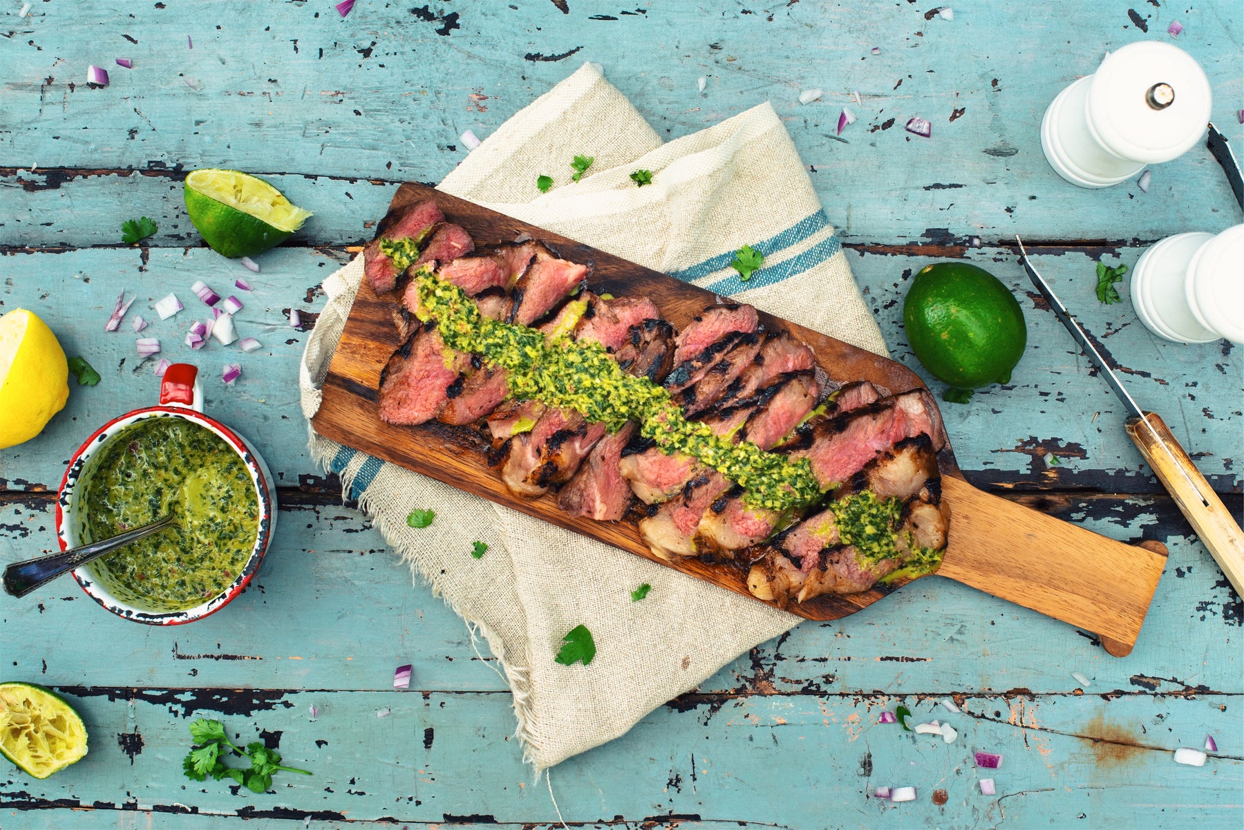 sliced steak covered with green sauce